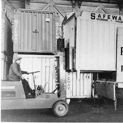 Safeway container being place in a truck by a forklift