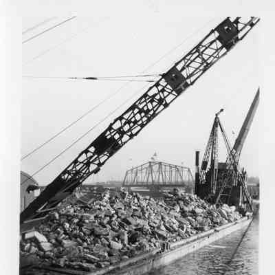 Barge Transport loaded with stone with swivel bridge in background
