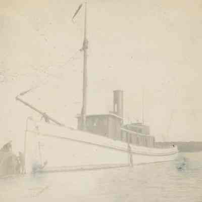 Workers securing ship's boiler