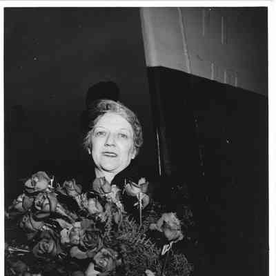 Mrs. Edward Frick holding roses