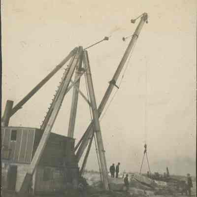 Workers loading large stone pieces