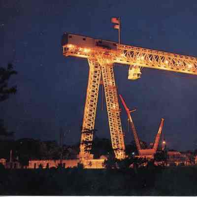 night scene of large gantry crane at Bay Shipbuilding