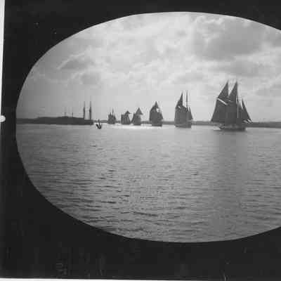 Tugboat towing six schooners