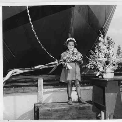 Little girl with bottle of christening champagne at SBSB&DD Co.