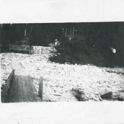 Woman on the shore in front of cottage