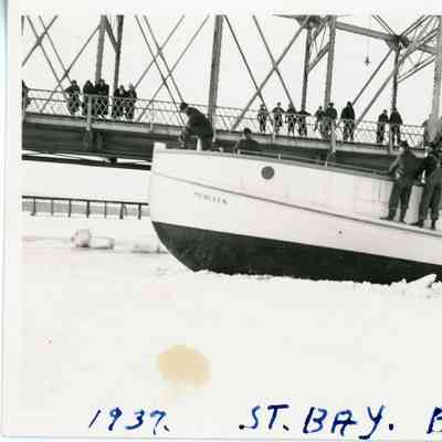 Fishing tug Merleen in ice next to Michigan Street Bridge