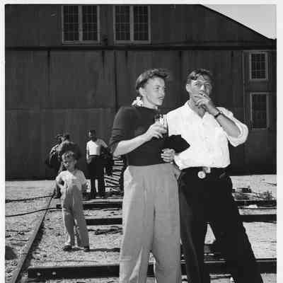 People drinking and smoking at christening of P-571 at Peterson Boat Works July 15, 1944