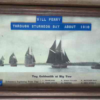 Framed photo of tug Goldsmith at head of big tow