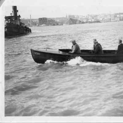 five men in motorboat underway
