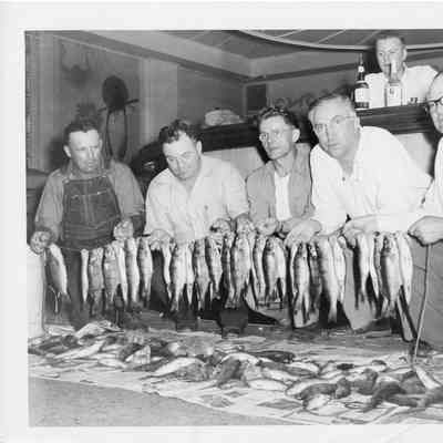 Five men holding a string of fish 1950