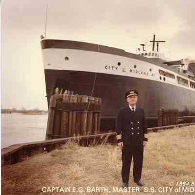 Captain E.G. Barth in front of City of Midland docked 1984