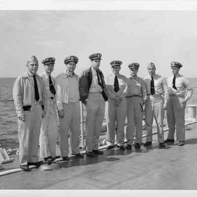 Eight men posing at christening of LST-1166, September 9, 1953