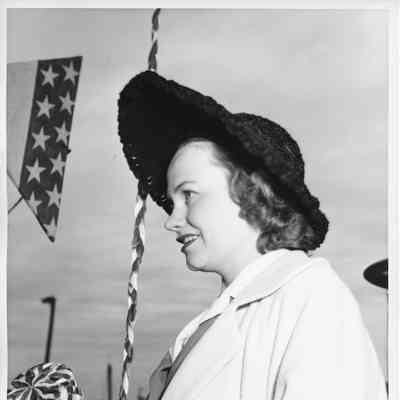Mrs. George Reeke holding christening bottle