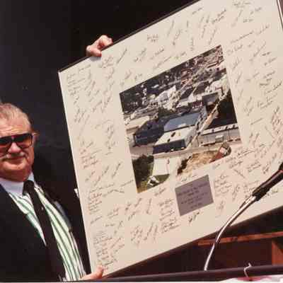 Guests holding photo of arial view of Kentucky Street 7/22/1987
