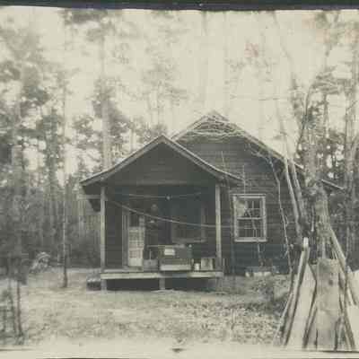 Man stands on porch of Kincaid's cottage