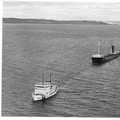 USCGC 103 Mobile Bay towing freighter
