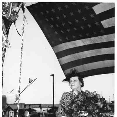 PC-825 ship sponsor Mrs. Zeidler holding flowers pre-christening
