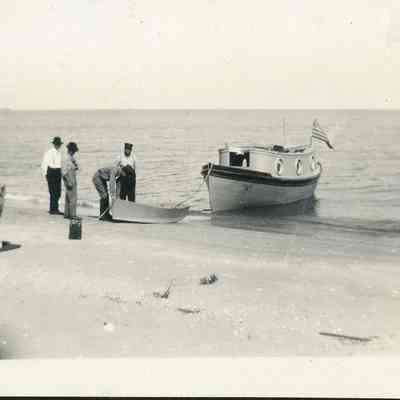 Four men next to USLHS vessel