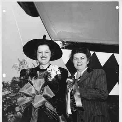 P-569 sponsor Mrs. Nick Propesur holding flower with woman holding christening bottle in front of P-569 May 20, 1944