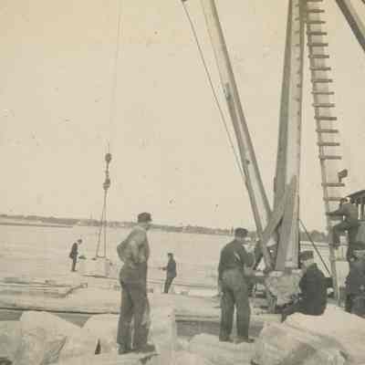 Workers loading large rock