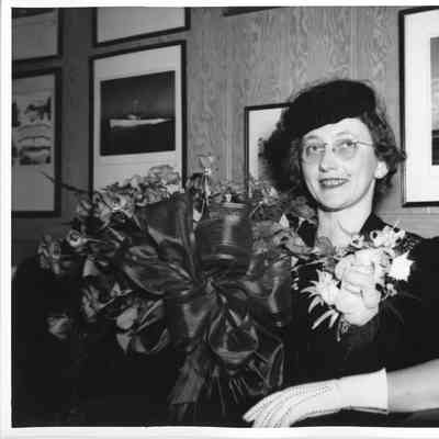 Mrs. John Butterweck holding roses
