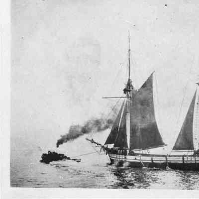 Schooner Minerva being towed by tugboat