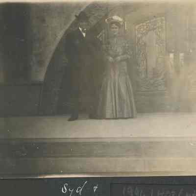 Couple posing at entrance of building