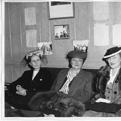 Three unidentified women sitting on couch