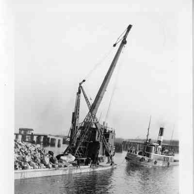 Barge Transport loaded with stone connected to tugboat