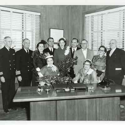 Group standing behind desk at christening of LST-1170, May 22, 1954