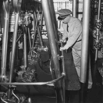Officer observing machinery of lighthouse tender Hollyhock