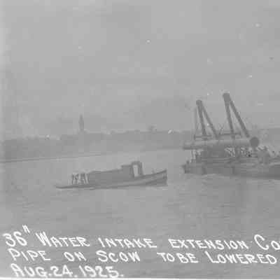 Pipe on scow to be lowered in place August 24, 1925