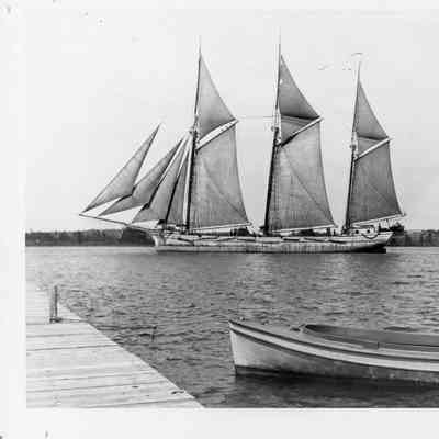 Three masted schooner Arendal with duck boat in foreground