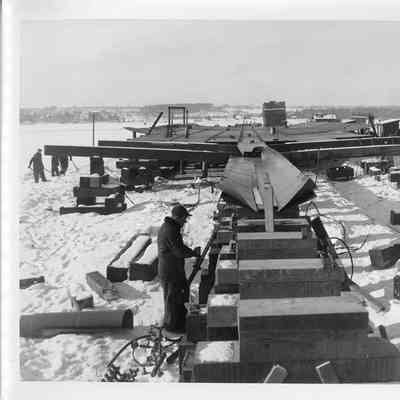 Hull of Spartan under construction in snow January 9, 1951