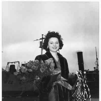Miss Denise Fenard holding W-22 Coutelas christening bottle and roses