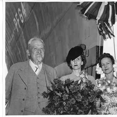 Reverand Edward F. Helmich, Mrs. Gus Johnosn, And Alva Smith in front of PF-64 USS Knoxville