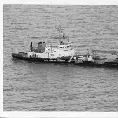 USCGC Mobile Bay with barge underway 1996
