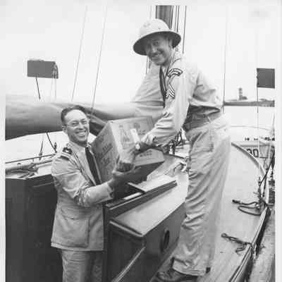Coast Guard police loading a case of Pabst Blue ribbon Beer on Half Moon