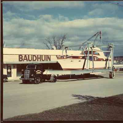 Boat in lift in fornt of Baudhuin Yacht Harobr Building