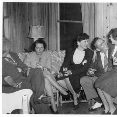 Unidentified two men and three women siting on couch