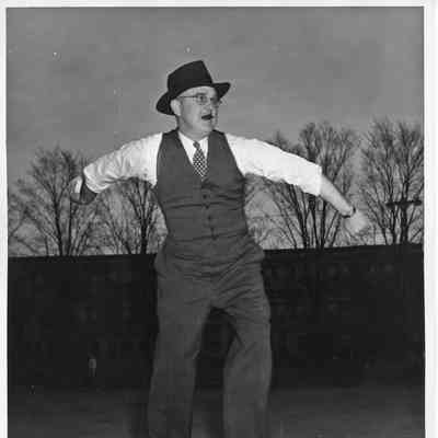 Man with cigar in suit throwing baseball