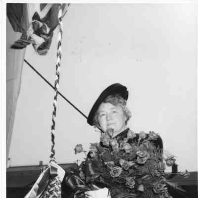 Mrs. William E. Wagener holding roses and christening bottle