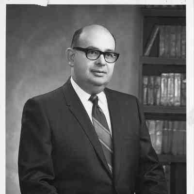 Arthur J. Zeulke in dark business suit standing in office