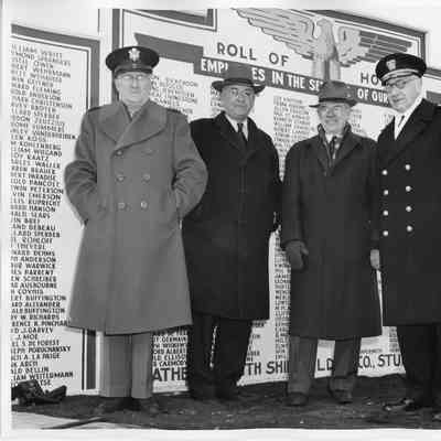 L.D. Smith and other standing in front of Roll of Honor sign