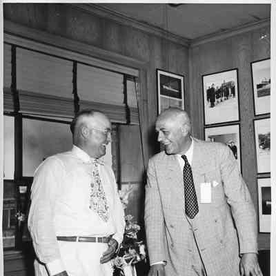 L.D. Smith laughing with unidentified man in L.D. Smith's office