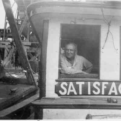 Man in pilothouse of Satisfaction
