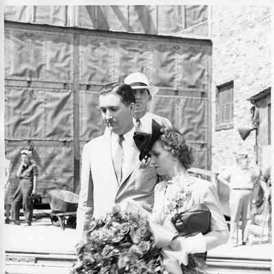 Unidentified man with Mrs. Gus Johnson holding roses