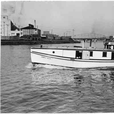 Fishing tug John V. Allie underway with railroad bridge in background