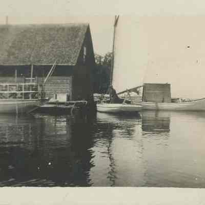 Man in sailboat at pier