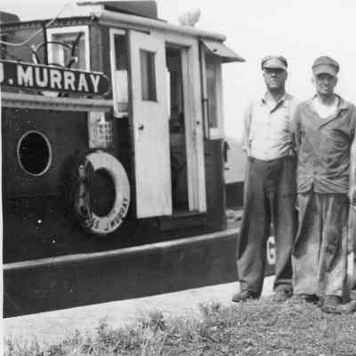 Four men standing next to James J. Murray in Sheboygan